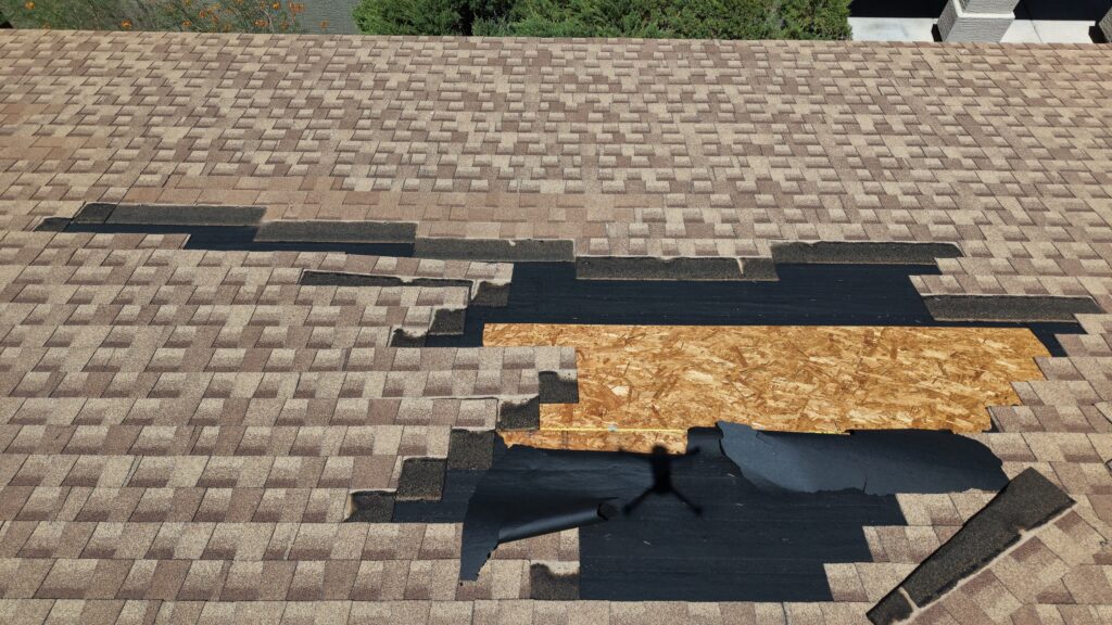 damaged asphalt shingle roof requiring repair in Phoenix Arizona