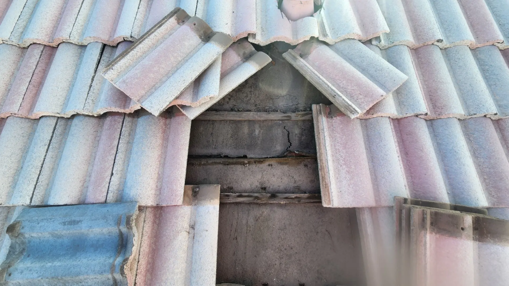 Tile roof underlayment failure beneath displaced concrete tiles in Phoenix Arizona